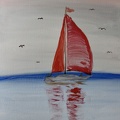 Segelboot mit roten Segeln auf der Ostsee